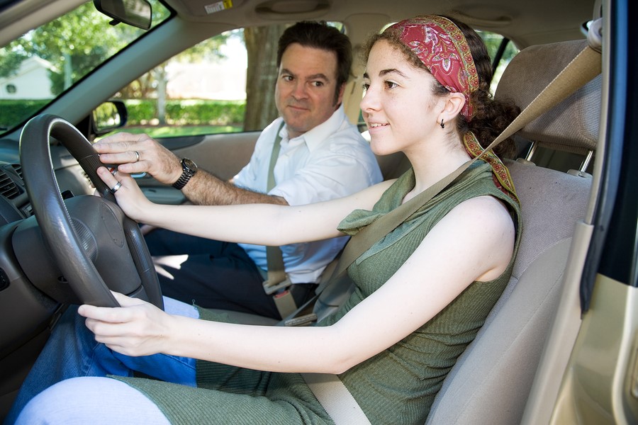 Auto Insurance Rates - teen daughter driving with dad